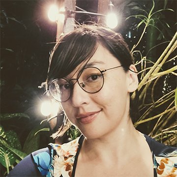 a woman in glasses and a floral top